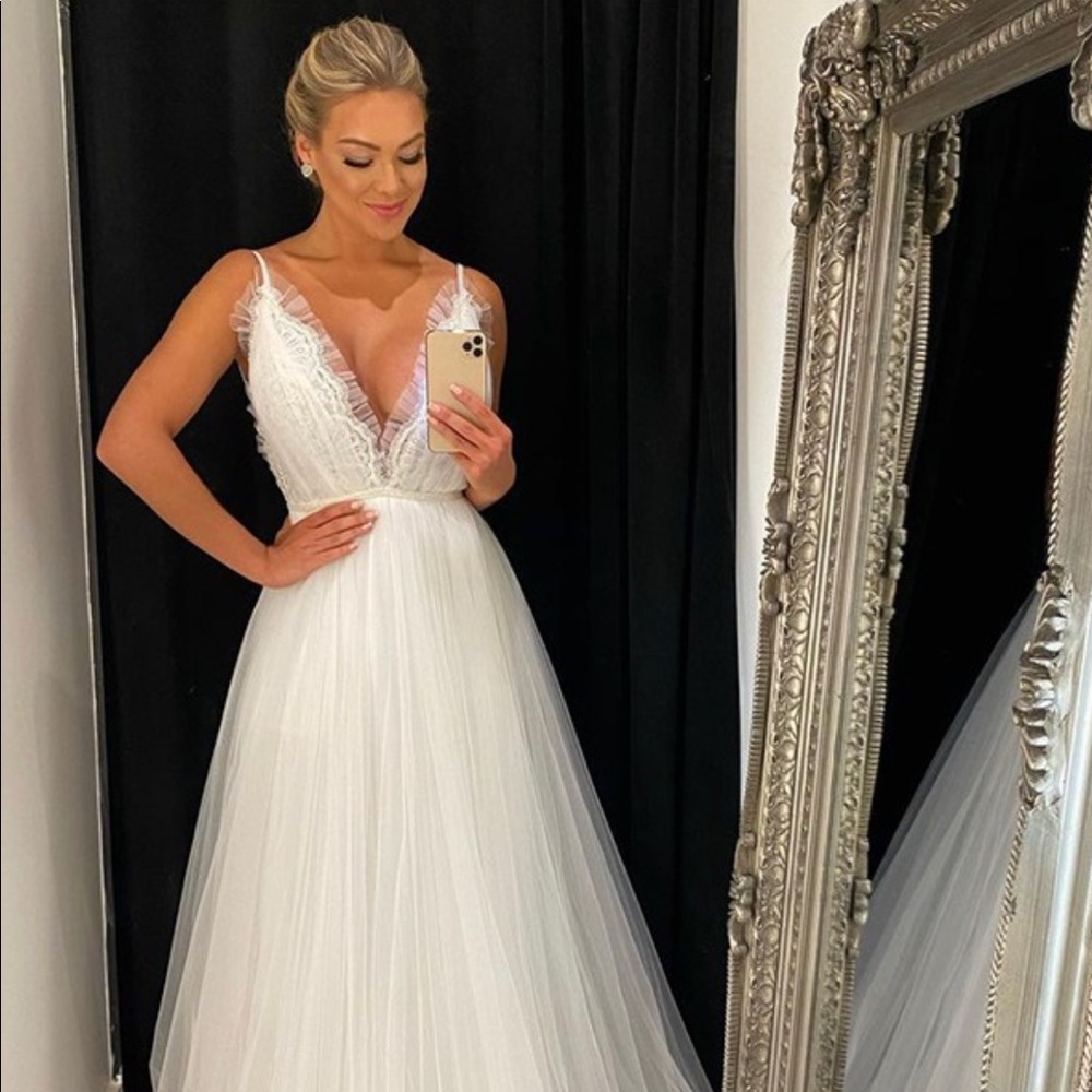 A beautiful bridal gown, never worn and nice and long.